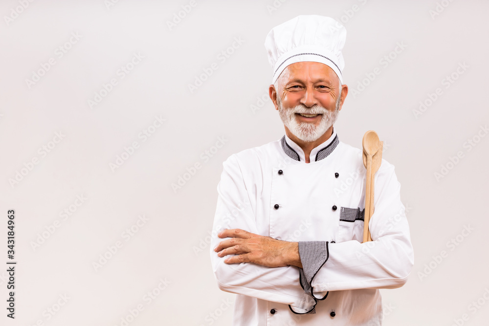 Portrait of senior chef with work tool on gray background. Portrait of senior chef with work tool on gray background.
