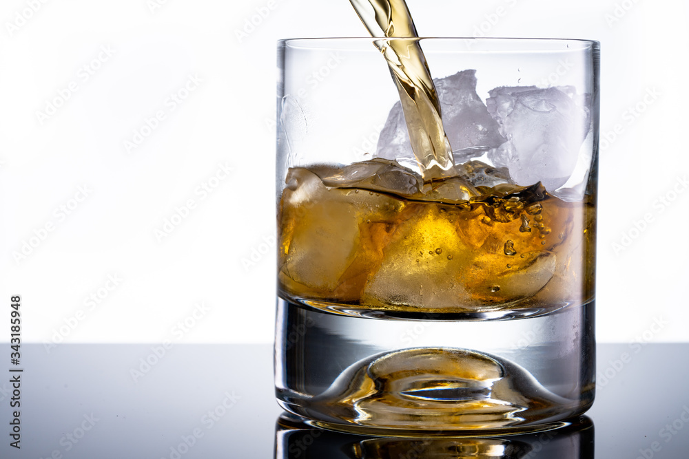 Glass of whiskey with ice cubes Glass of whiskey with ice cubes