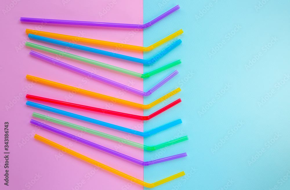 Plastic straws for cocktails. Pastel pink and blue colors. Summer vibes. Hipster party with beverages. Plastic straws for cocktails. Pastel pink and blue colors. Summer vibes. Hipster party with beverages.