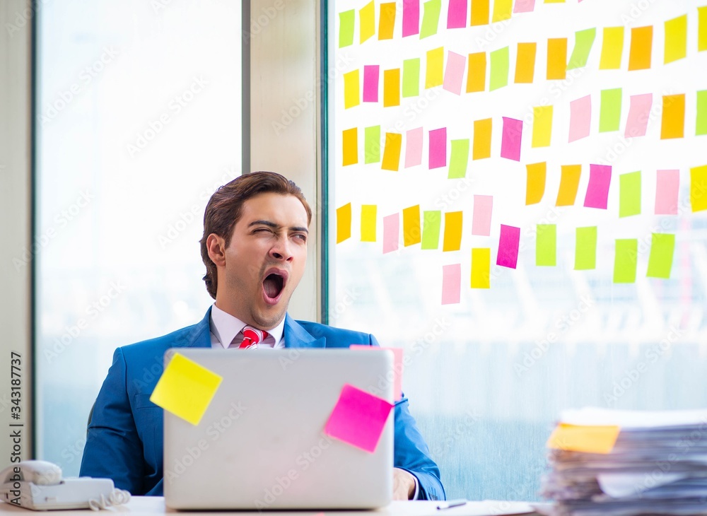 Young handsome employee with many conflicting priorities Young handsome employee with many conflicting priorities