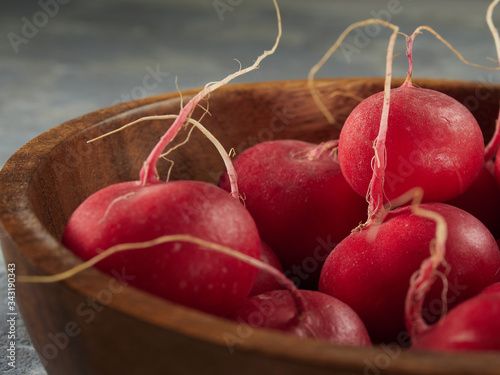 Ripe red radishes lie on a gray background.Healthy food.Red radish on a concrete background