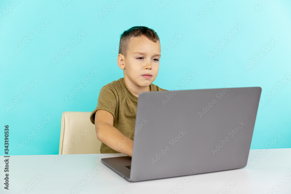 Online home learning concept. Boy sitting with computer and doing homework Online home learning concept. Boy sitting with computer and doing homework