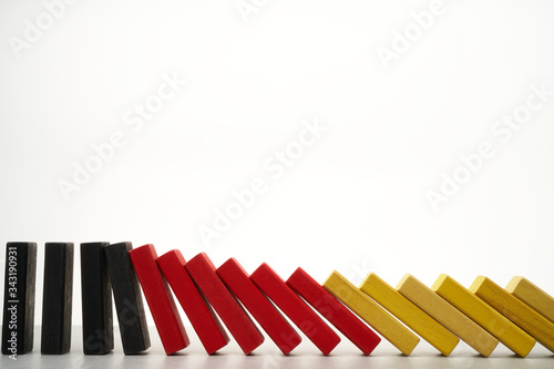 domino effect of german flag with colored bricks on white background
