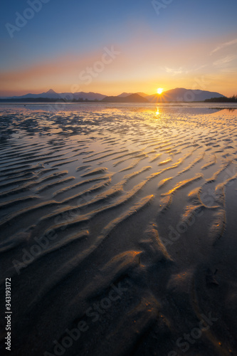 Beautiful sunrise view of low tide beach sand texture show up in morning