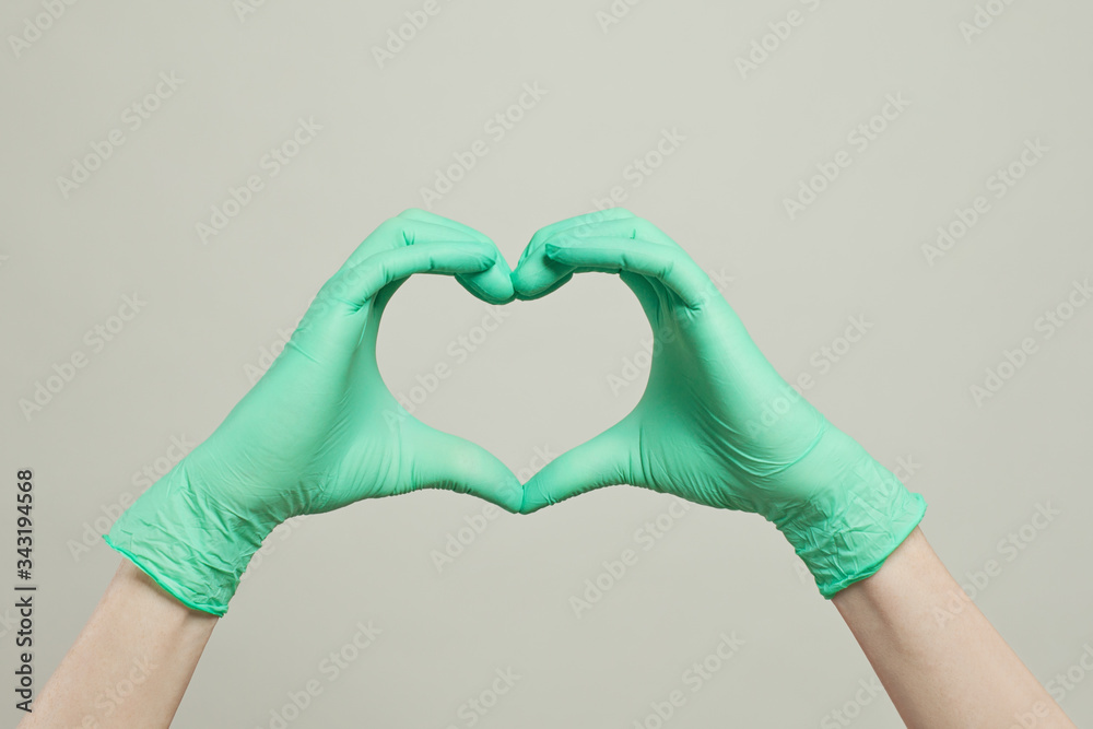 Heart of doctor gloves hands. The heart from the hands in medical gloves on white background Heart of doctor gloves hands. The heart from the hands in medical gloves on white background
