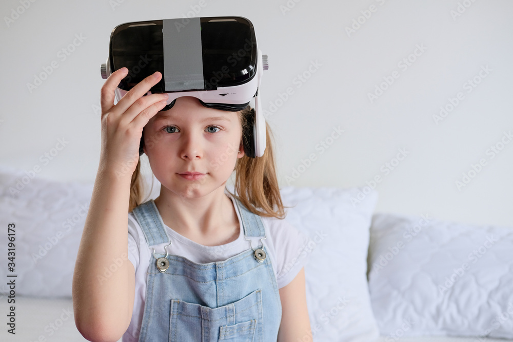 schoolgirl girl in glasses of veto reality plays. Fun holiday for a little girl at home in quarantine self-isolation schoolgirl girl in glasses of veto reality plays. Fun holiday for a little girl at home in quarantine self-isolation