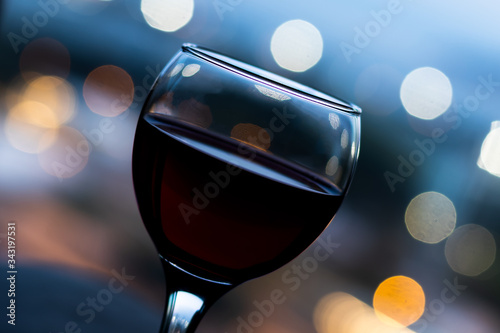 glass of wine and city lights,bokeh with landscape