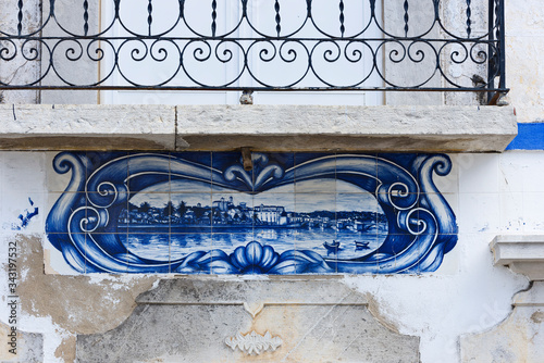 traditional azulejos panel on the facade of a house in Tavira, Algarve, Portugal