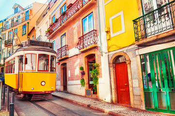 Yellow vintage tram on the street in Lisbon, Portugal. Famous travel destination
