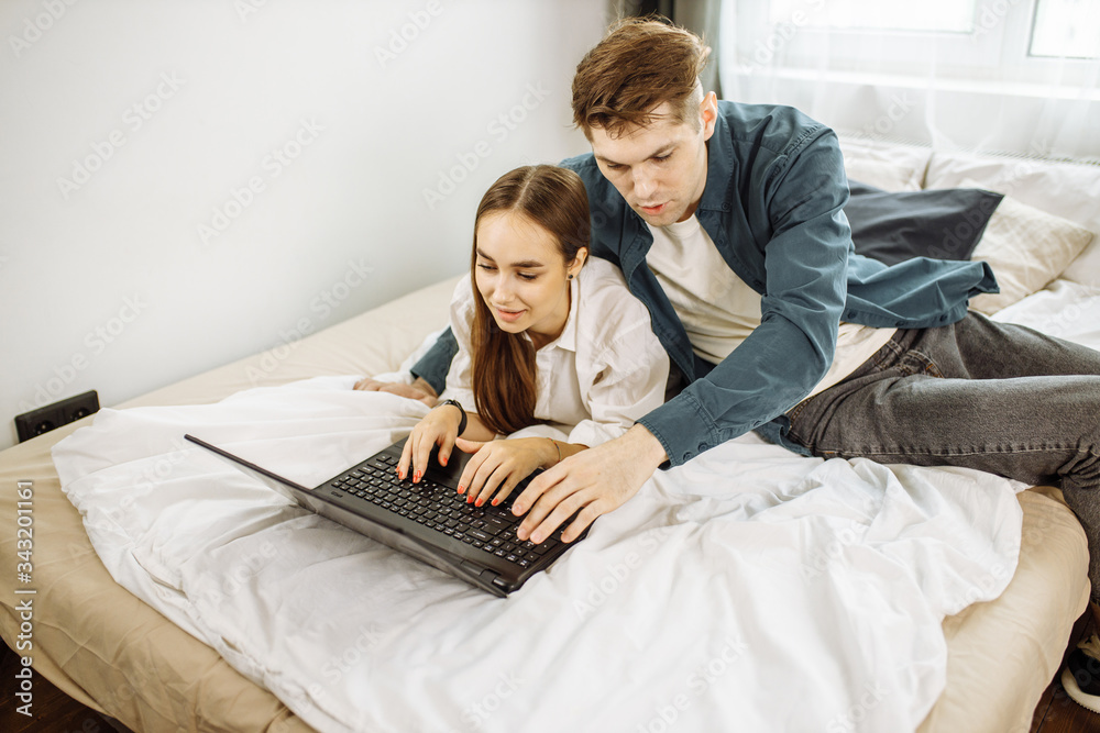 young caucasian couple have rest at home, they use laptop, want to watch film online together. surf the Net, leisure, rest, relax young caucasian couple have rest at home, they use laptop, want to watch film online together. surf the Net, leisure, rest, relax