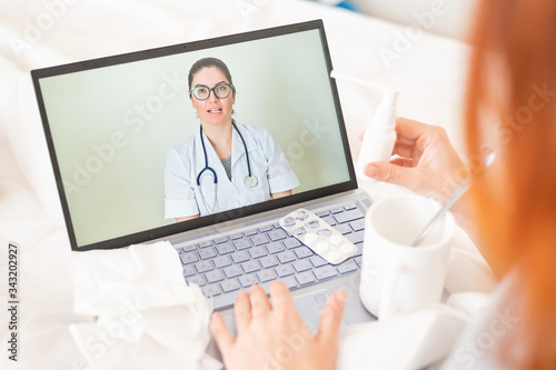 Unrecognizable girl is watching a video with medical prescriptions on a laptop. A woman conducts an online conversation with the attending physician. The doctor gives an online consultation.