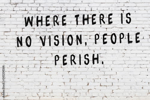 Фотография Black painted inscription of smart quote on white brick wall