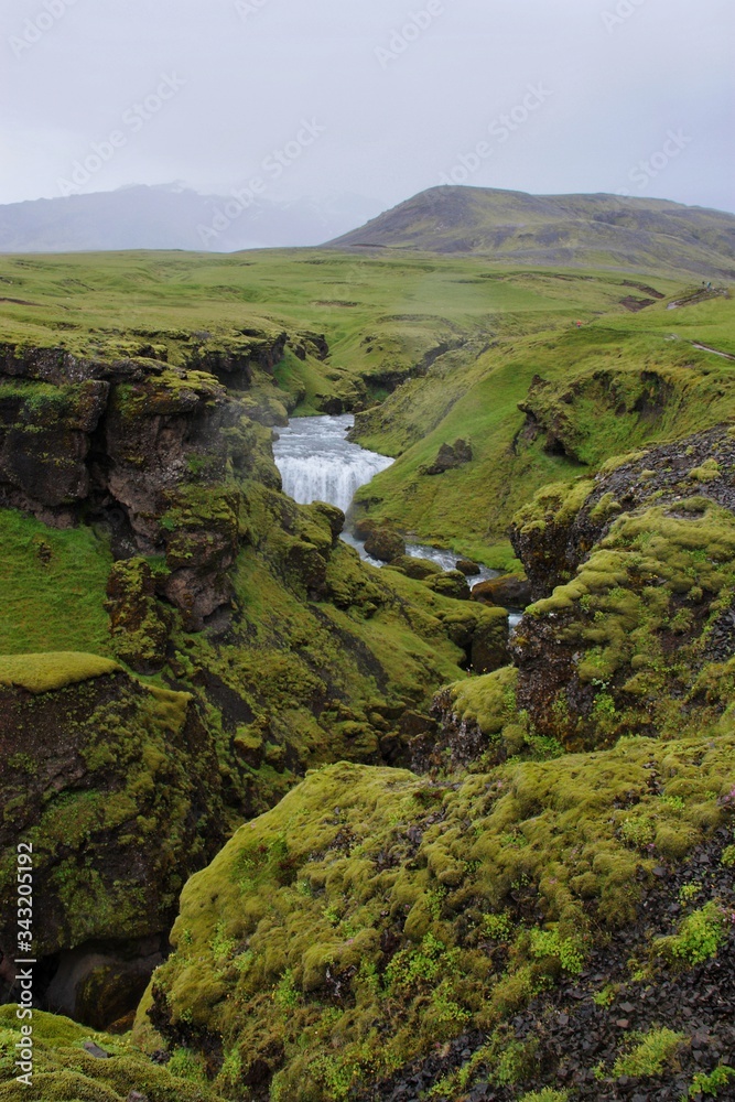 the canyon through which the river flows Skogar, cloudy day, Iceland's nature