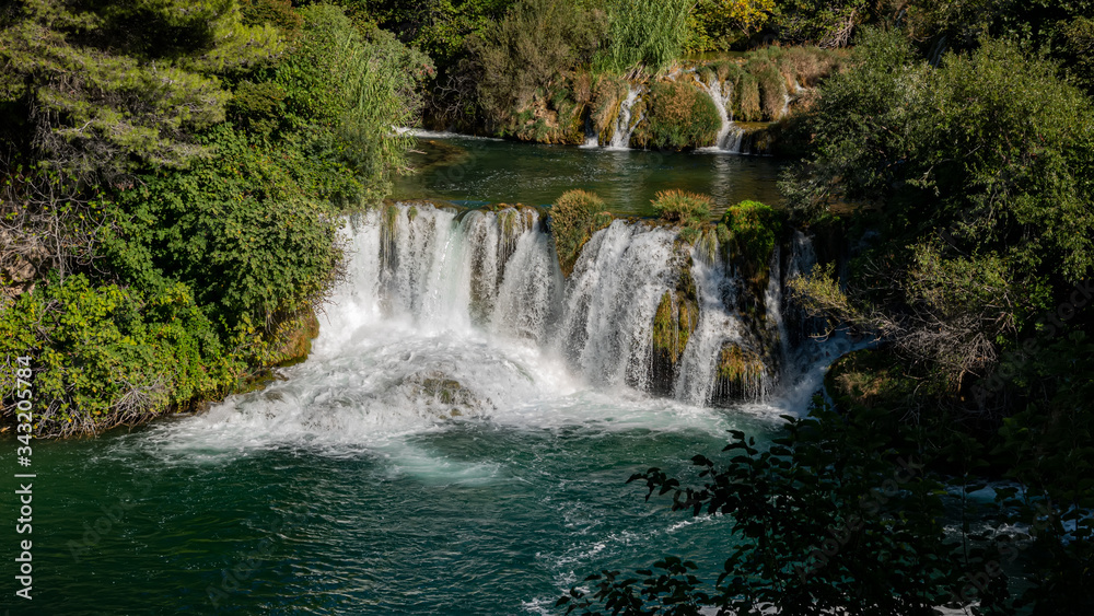 Amazing view of the natural Krka waterfalls. Sunny day, view of the Krka National Park located by Roski Slap in Croatia. Amazing view of the natural Krka waterfalls. Sunny day, view of the Krka National Park located by Roski Slap in Croatia.
