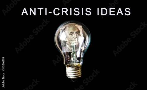 Lamp bulb with a money inside.  Anti-Crisis strategy. Rising on price. New idea concept. No money. Economy crisis, poverty, unemployment concept. Coronavirus, isolation. Inflation rates.