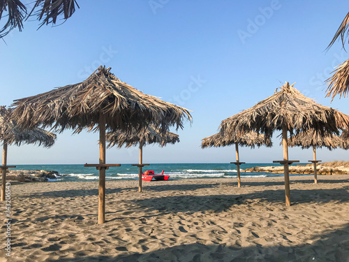 Empty beach area with umbrellas for tourists isolated on distance 