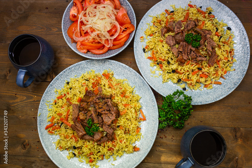 Samarkand pilaf. lamb,rice,onion,yellow carrots,vegetable oil,spices. on the table in kicks not mixing.Uzbek national dish.The horizontal projection of the.