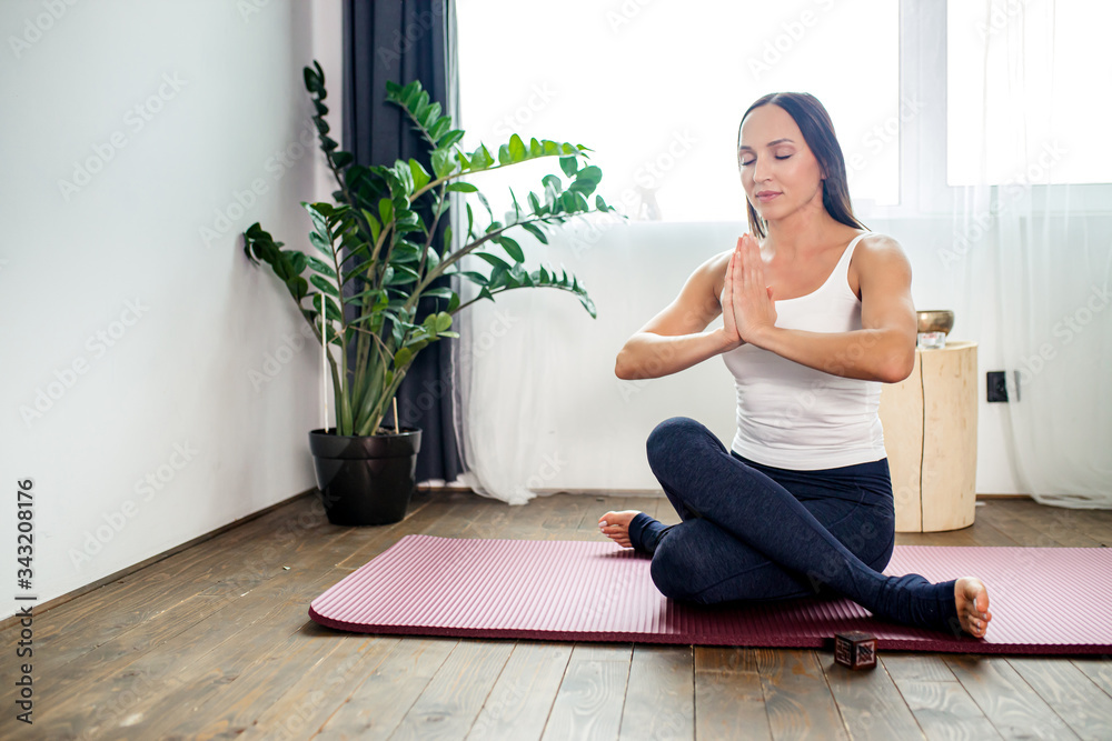 young caucasian woman meditate with crossed legs, lady in sporty clothes keep calm, do yoga exercises indoors young caucasian woman meditate with crossed legs, lady in sporty clothes keep calm, do yoga exercises indoors