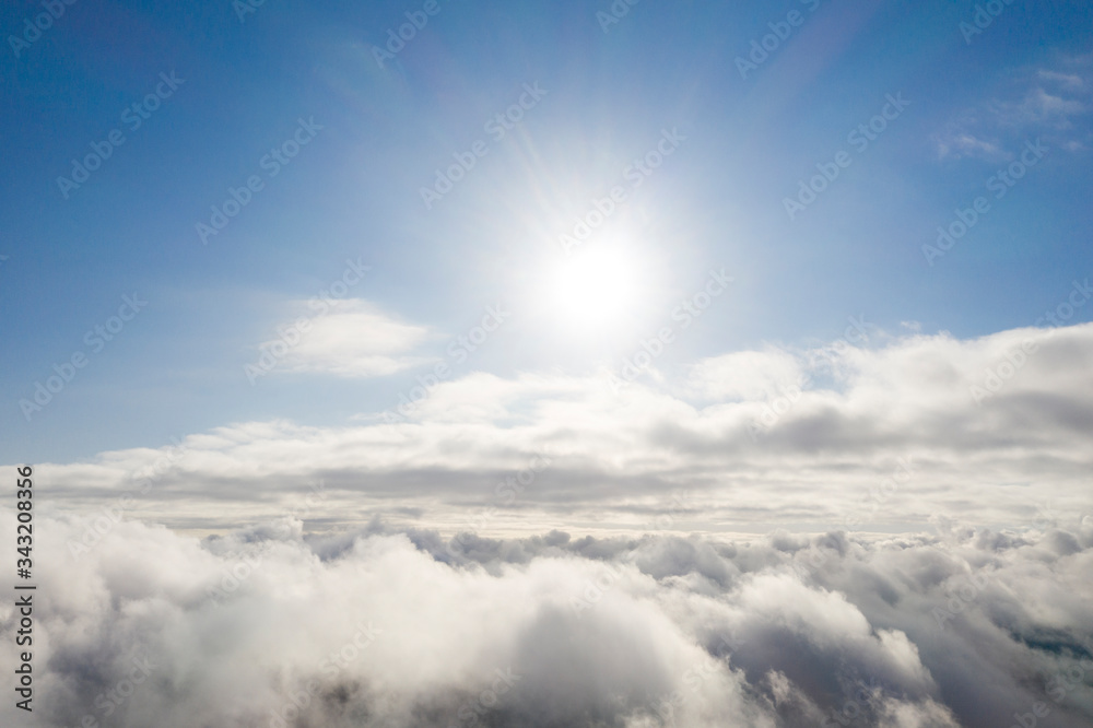 Aerial view white clouds in blue sky. View from drone. Aerial top view cloudscape. Texture of clouds. View from above. Sunrise or sunset over clouds. Panorama clouds