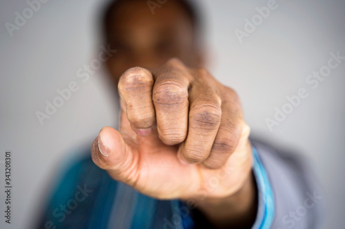 Selective focus on a black man fist hand. African american culture history concept. Ethnic people and african lifestyle. © beavera