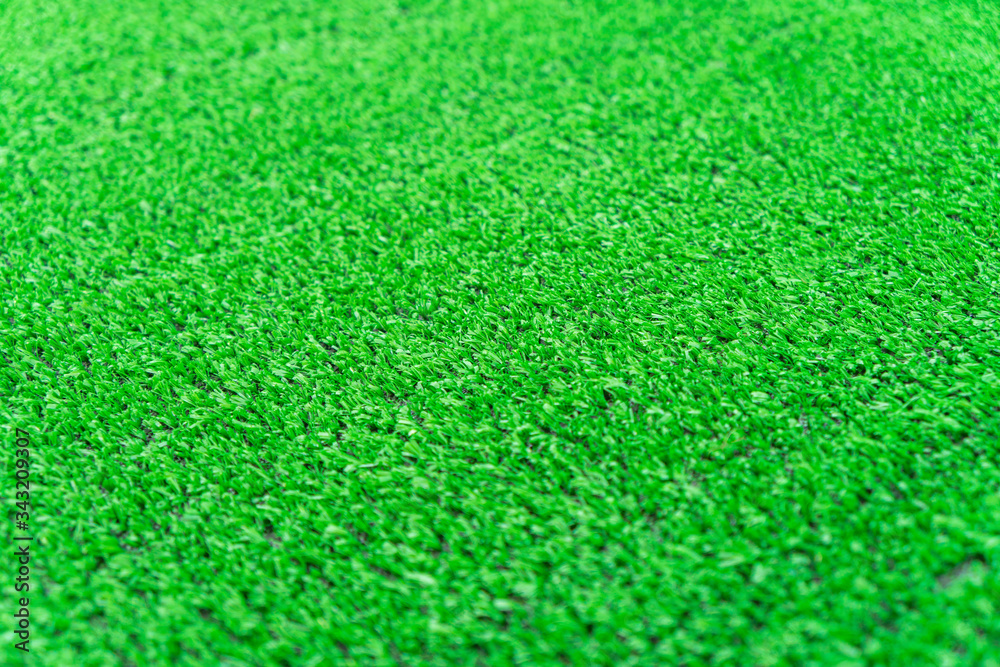 Fototapeta premium Artificial grass lawn texture. Artificial Turf Background. Greening with an artificial grass. Artificial turf laying background texture. Synthenic grass layer