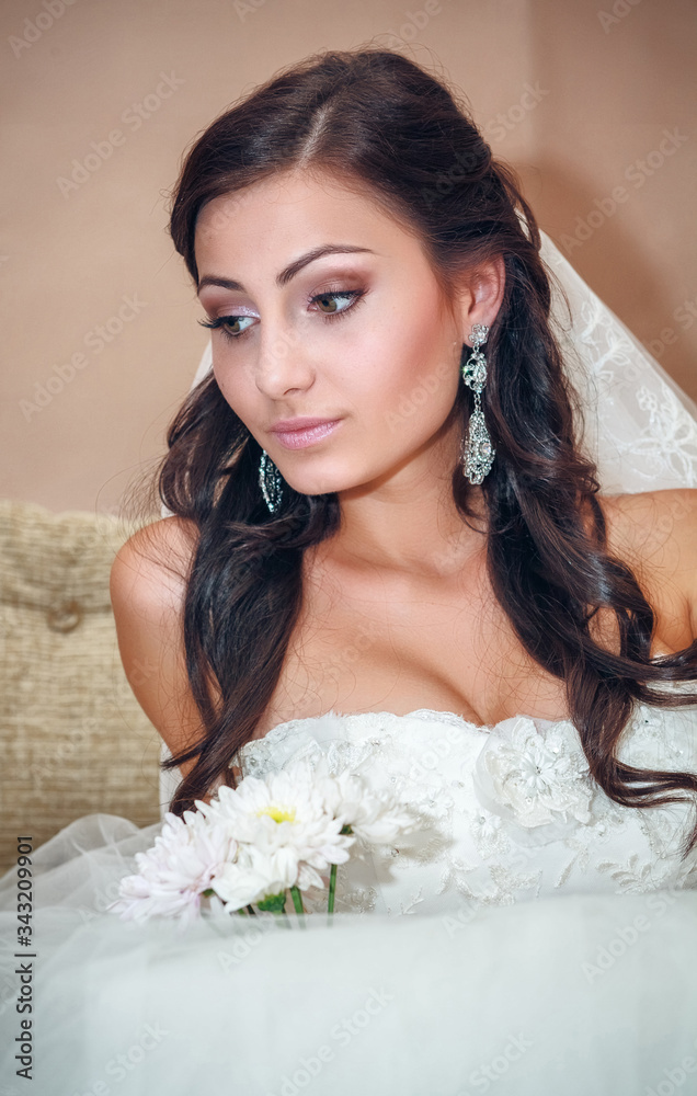 portrait of a bride near the window on a wedding day