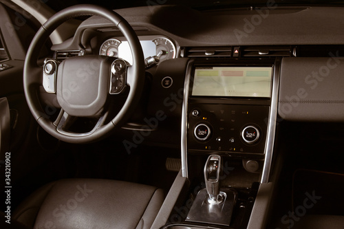 Luxury car inside, automatic gear stick of a modern car. Dark leather interior brown toned image