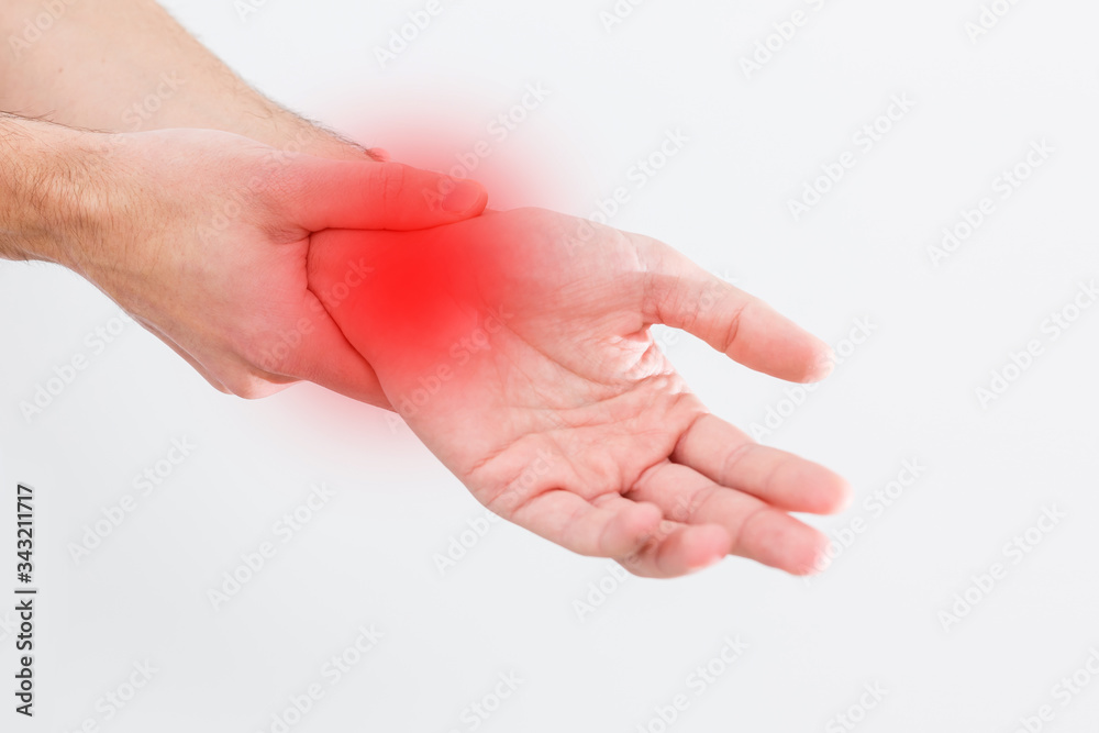 man's wrist hurts. A damaged female hand hurts. Hands suffer from work, sports injury. Sore spot is highlighted in red. Isolated white background.