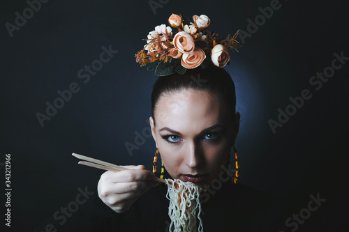 Beautiful girl eats noodles doshirak.
Studio photography, filter stylized photography photo