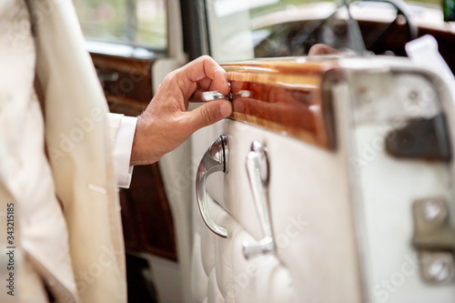 Open a vintage wedding rolls royces car door in withe coral