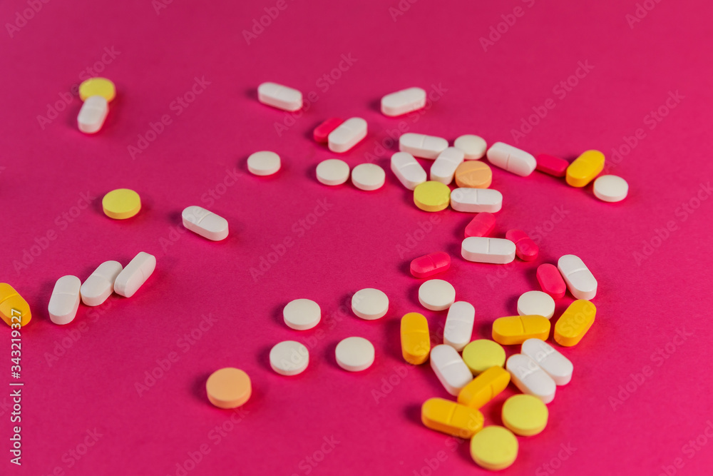 Different medicine pills, tablets on pink background. Many pills and tablets with space for text. Health care. Top view. Copy space. New image. Pharmaceutical picture. Closeup. Soft focus. Close-up Different medicine pills, tablets on pink background. Many pills and tablets with space for text. Health care. Top view. Copy space. New image. Pharmaceutical picture. Closeup. Soft focus. Close-up