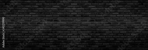 Panorama Black brick walls that are not plastered background and texture. The texture of the brick is black. Background of empty brick basement wall.