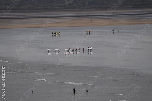 Photography Surfers returning from their surfing lessons at Westward Ho!