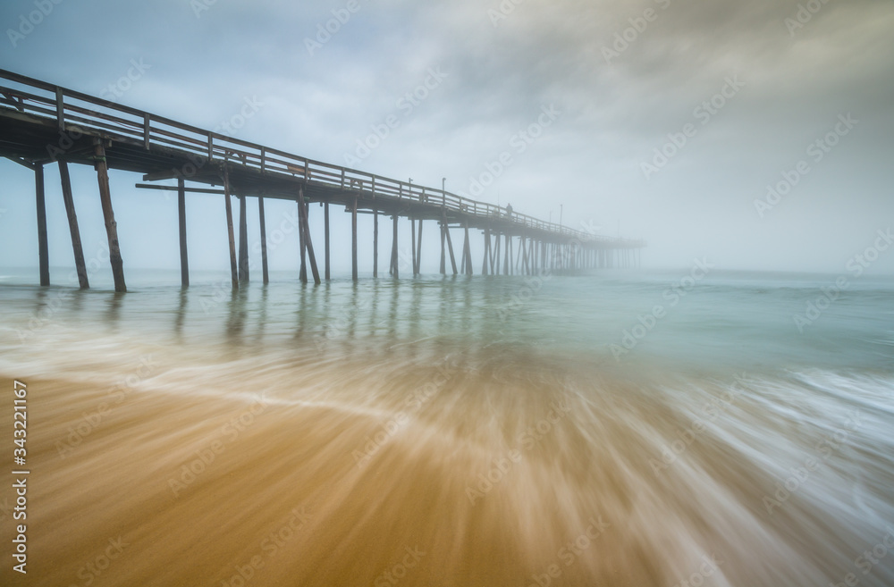 Nags Head Beach Outer Banks North Carolina ocean scenic seascape photography of fog and moving surf waves on the beach at the NC Outer Banks Fishing Pier. .