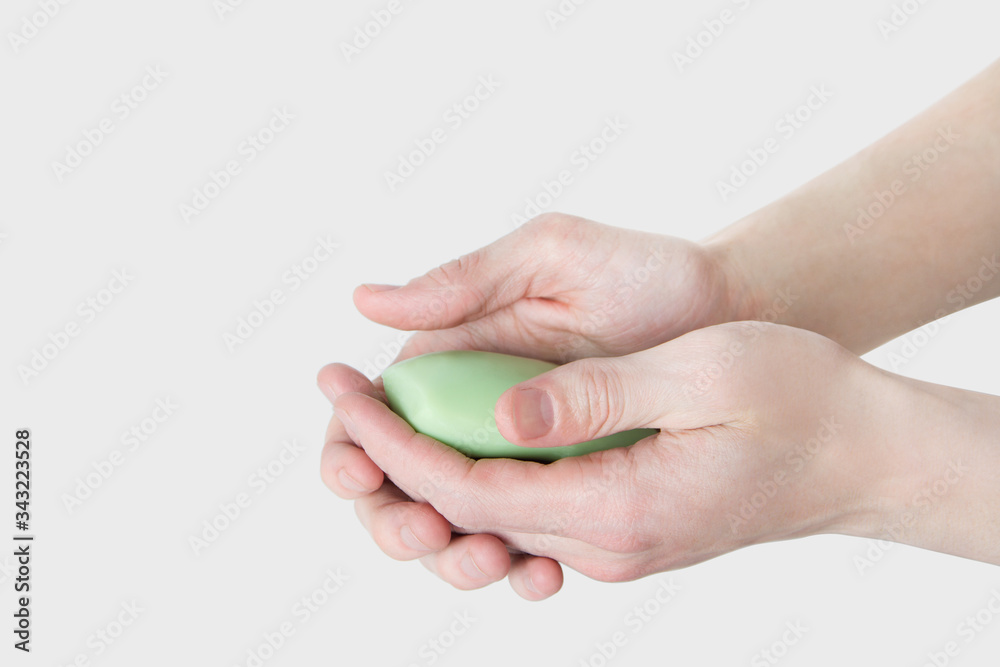 Washing hands with soap isolated on white background close-up. Man holds a bar of soap in his hands. Please wash your hands concept Washing hands with soap isolated on white background close-up. Man holds a bar of soap in his hands. Please wash your hands concept