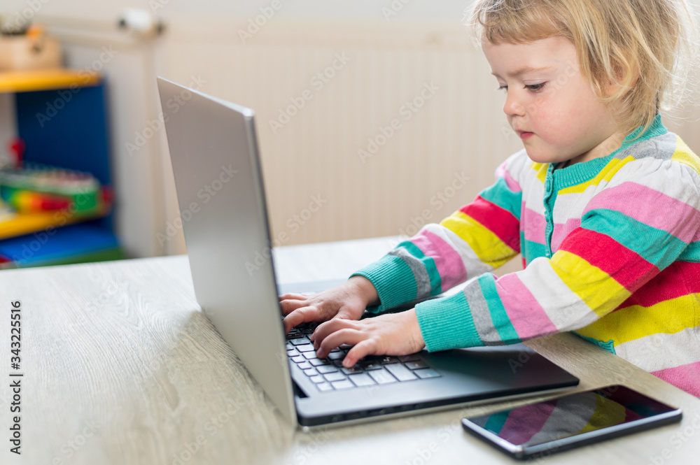 Cute blonde girl using mobile while working on computer. Cute blonde girl using mobile while working on computer.