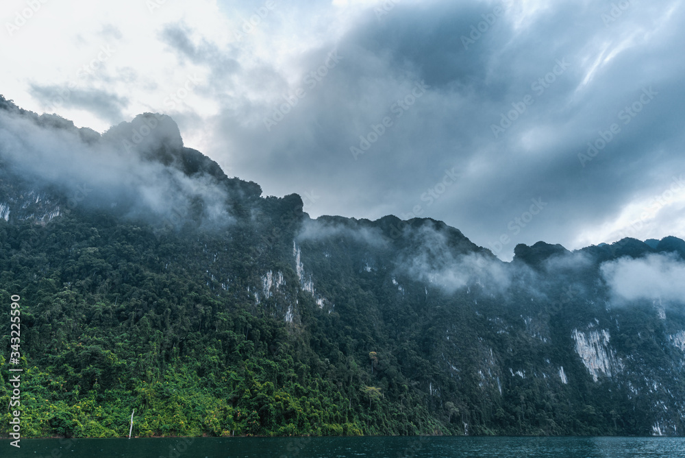 Fog in the mountains. Tropical landscape in Thailand. Cheo Lan Lake and Khao Sok National Park.