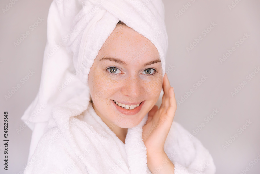 Young woman in a bathrobe and towel on her head Young woman in a bathrobe and towel on her head
