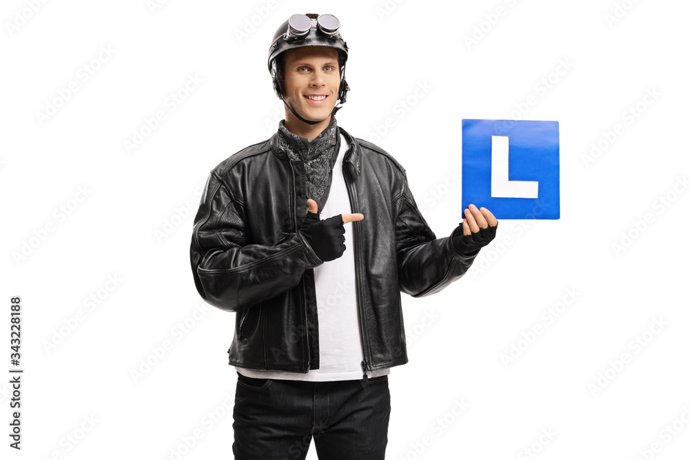 Young man biker holding a drivers learning plate and pointing Young man biker holding a drivers learning plate and pointing