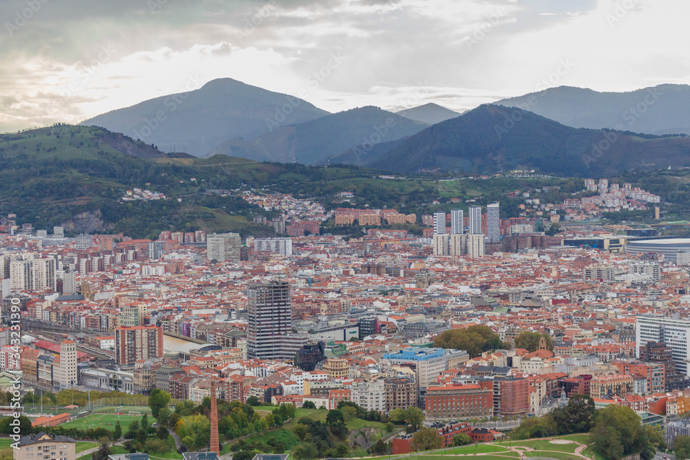 Panoramic Bilbao landmark. Aerial view of Bilbao, Spain. Capital of Basque country, Spain. Bilbao with mountains on background. Destination and travel concept. Bilbao sightseeing. Spanish landscapes. 