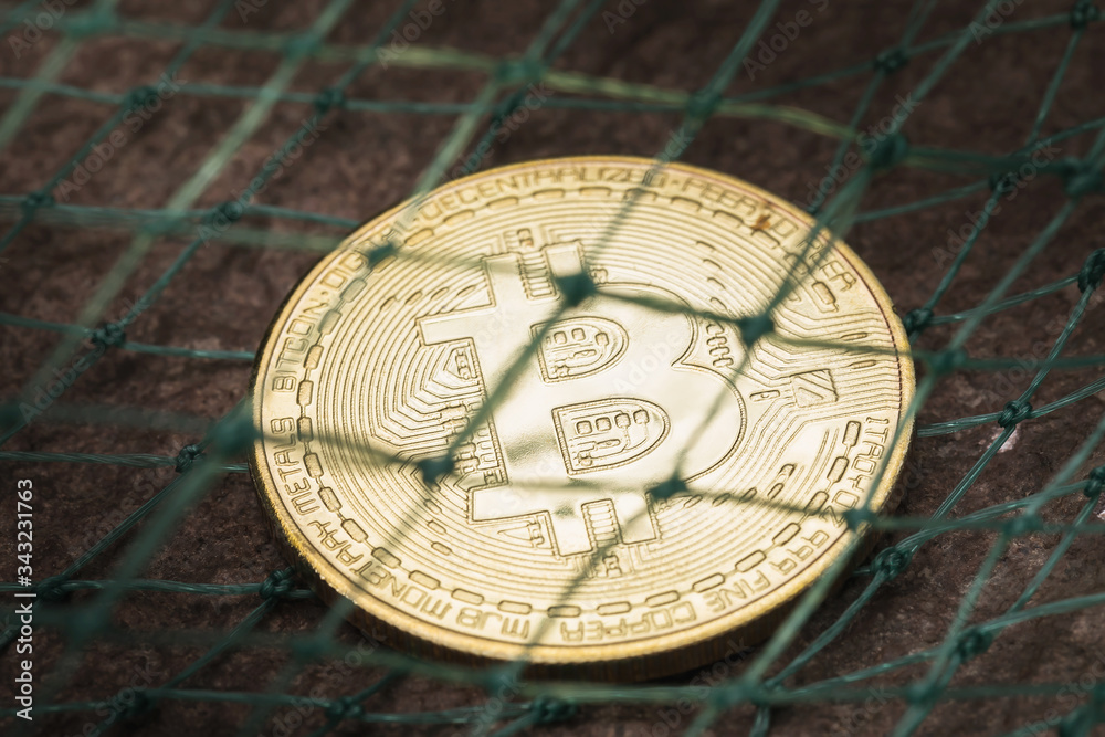 Obraz premium Bitcoin covered by the network. Concept on the threat of digital currency