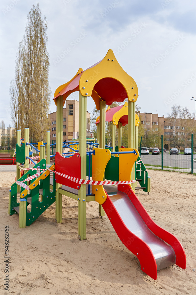 A closed playground for children with tape during the COVID-19 pandemic, Coronavirus. A closed playground for children with tape during the COVID-19 pandemic, Coronavirus.