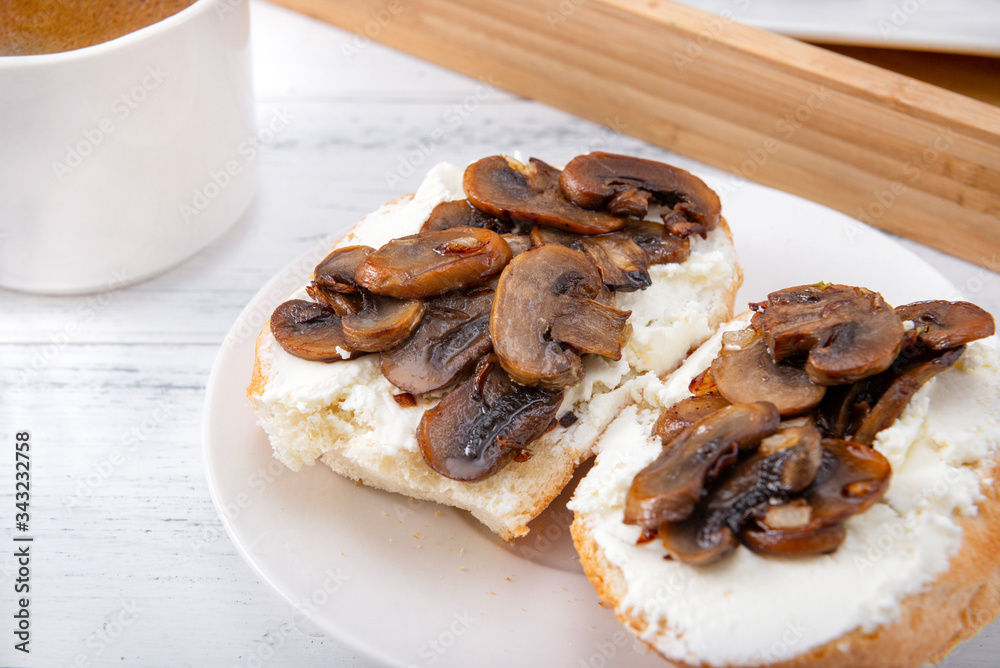 sandwiches with cheese and mushrooms on a plate, a Cup of black coffee on a white background, sandwiches with cheese and mushrooms on a plate, a Cup of black coffee on a white background,