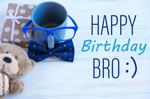 Happy Birthday bro. Brother and friend birthday greeting card design. Tie butterfly, cup and toy bear.