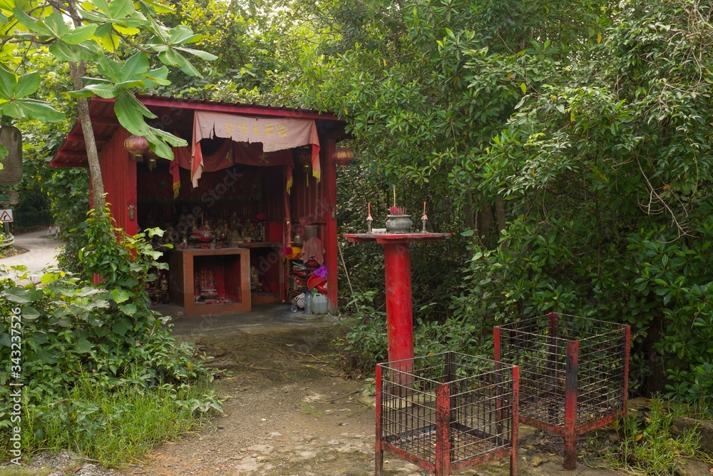 Buddhist Red Wayside Shrine on Tropical Pulau Ubin Island, Singapore Buddhist Red Wayside Shrine on Tropical Pulau Ubin Island, Singapore