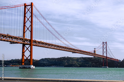 Fototapeta Naklejka Na Ścianę i Meble -  25th of April Bridge over the Tagus river, connecting Almada and Lisbon in Portugal