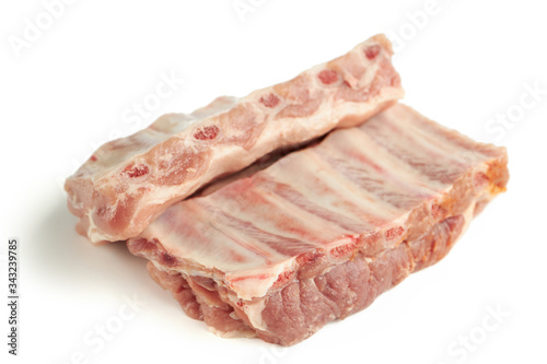 fresh raw pork ribs isolated on a white background. two pieces. ingredient for meat cuisine. side view