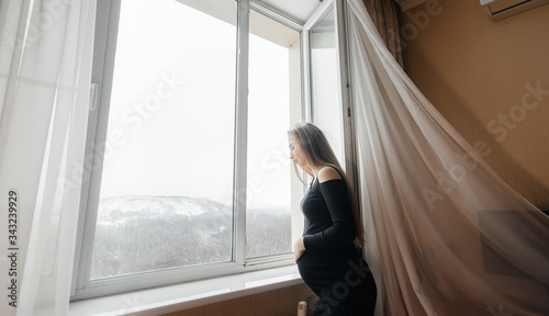 A pregnant girl opens a window to get some fresh air Free Download A pregnant girl opens a window to get some fresh air - GFXLoad