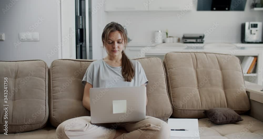 Happy brunette woman working at home, studying at home. Finished work. I am glad that the work is over. Emotional woman. Quarantine isolation. Close-up woman portrait Happy brunette woman working at home, studying at home. Finished work. I am glad that the work is over. Emotional woman. Quarantine isolation. Close-up woman portrait