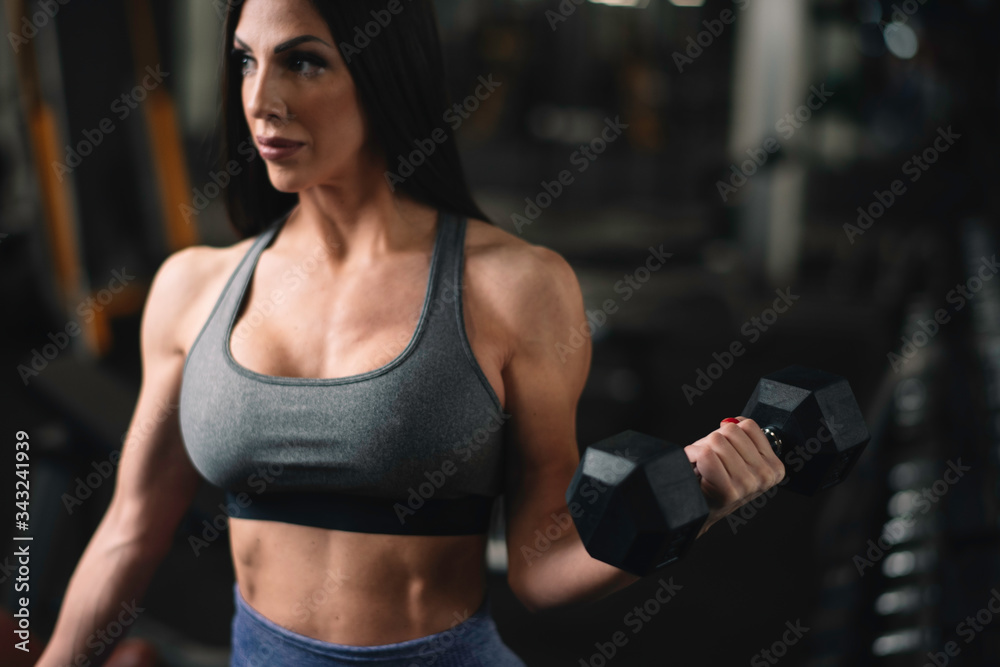 Fototapeta premium Fitness woman on training. Young woman in the gym. 